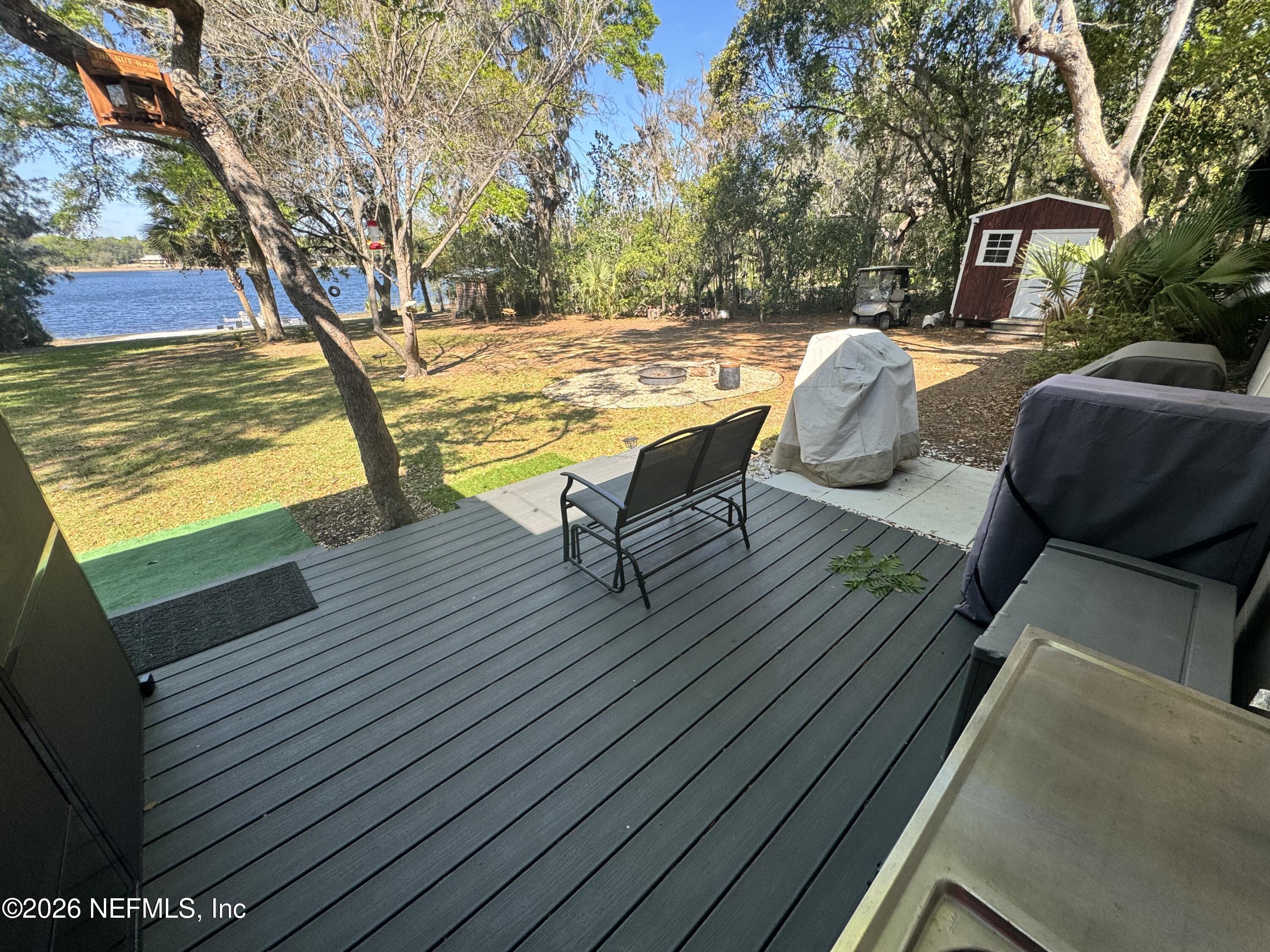 113 Stock Avenue Interlachen, FL 32148 - Photo 32 of 50 a view of swimming pool with lounge chair and dinning table under an umbrella
