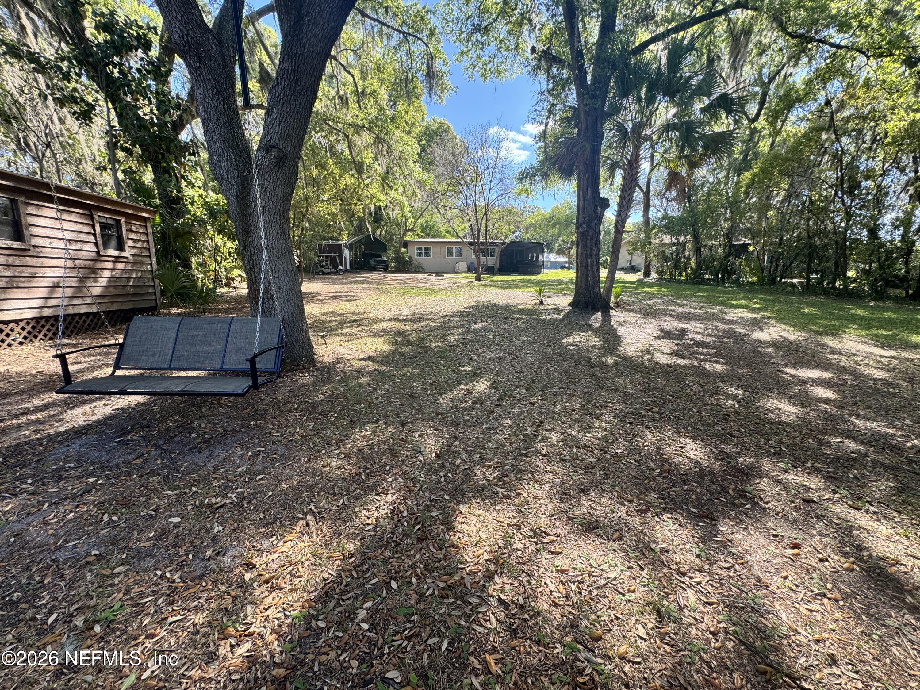 113 Stock Avenue Interlachen, FL 32148 - Photo 37 of 50 a view of outdoor space with deck and tree
