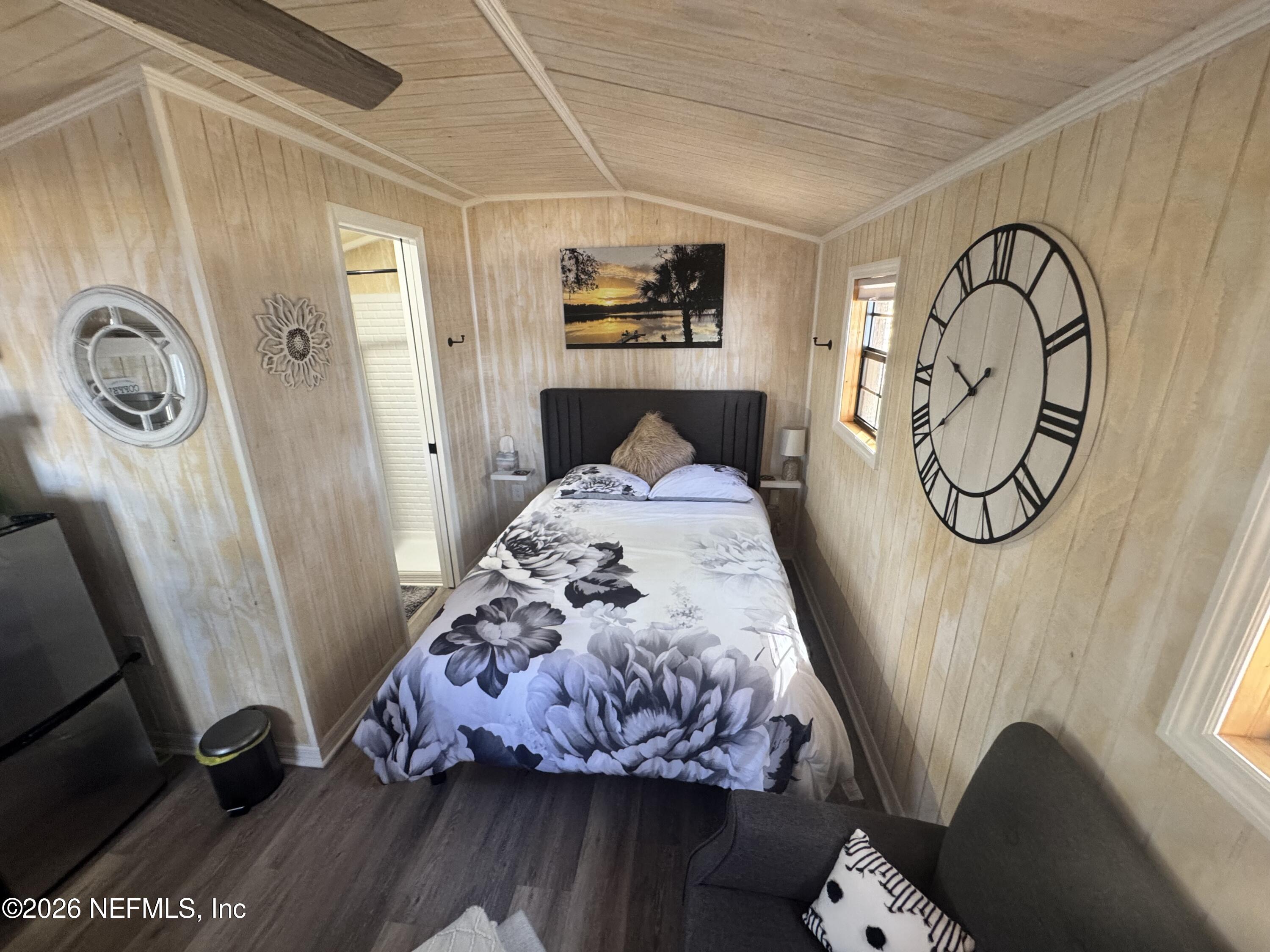 113 Stock Avenue Interlachen, FL 32148 - Photo 41 of 50 a bed sitting in a bedroom next to a window
