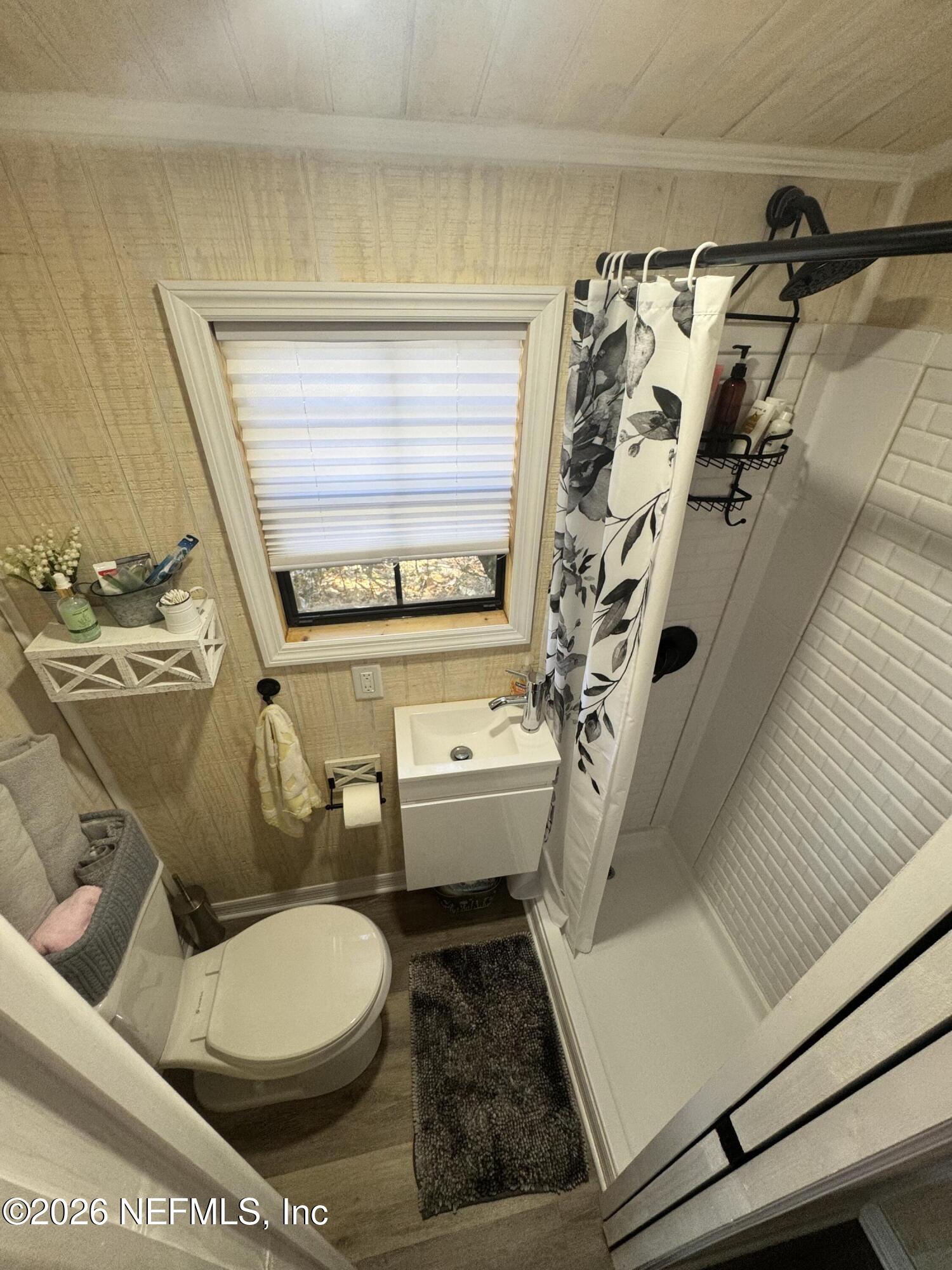 113 Stock Avenue Interlachen, FL 32148 - Photo 42 of 50 a white toilet sitting next to a bathroom sink