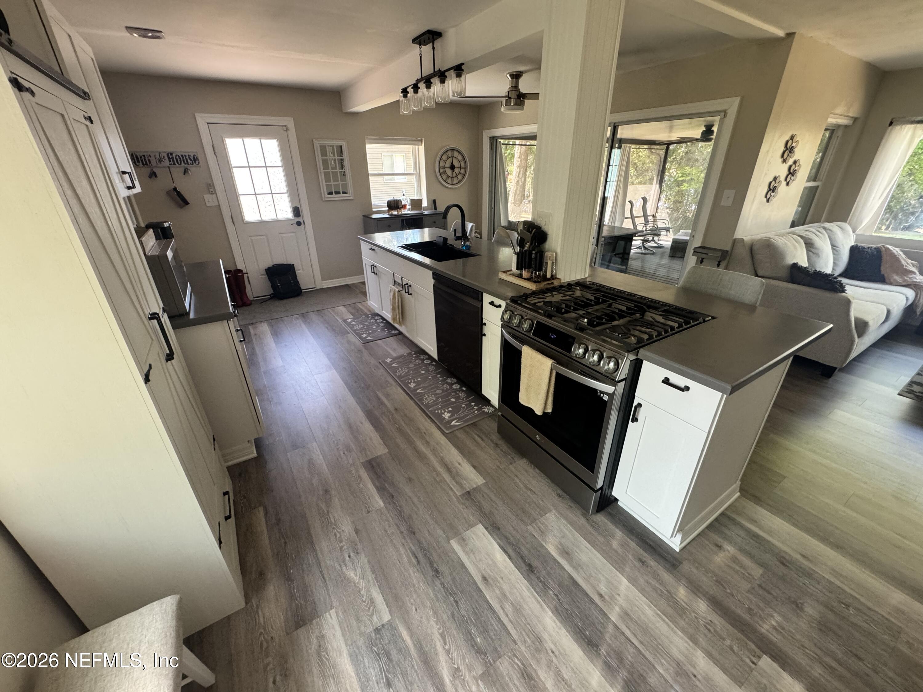 113 Stock Avenue Interlachen, FL 32148 - Photo 6 of 50 a kitchen with sink a stove and refrigerator