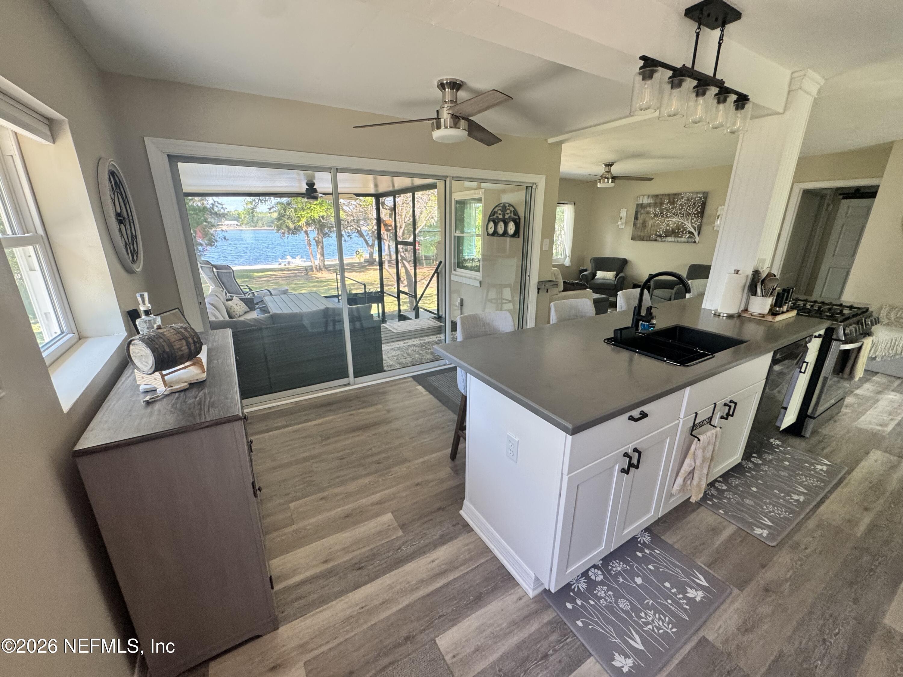 113 Stock Avenue Interlachen, FL 32148 - Photo 7 of 50 a kitchen with stainless steel appliances granite countertop a sink and a stove