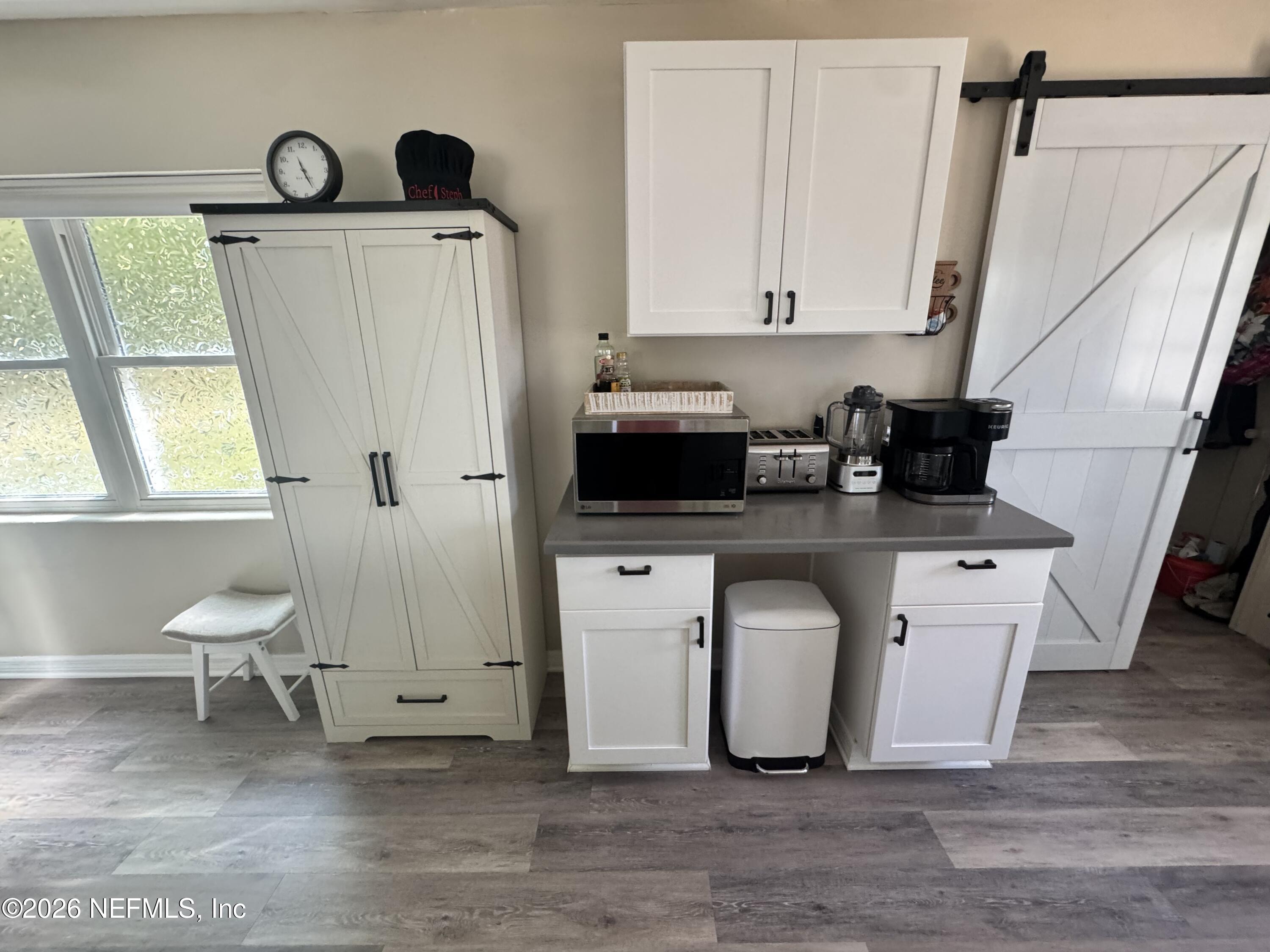 113 Stock Avenue Interlachen, FL 32148 - Photo 8 of 50 a white kitchen with a sink a toilet and a window