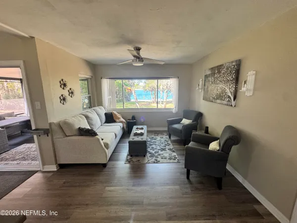 a view of swimming pool with lounge chair and dinning table under an umbrella