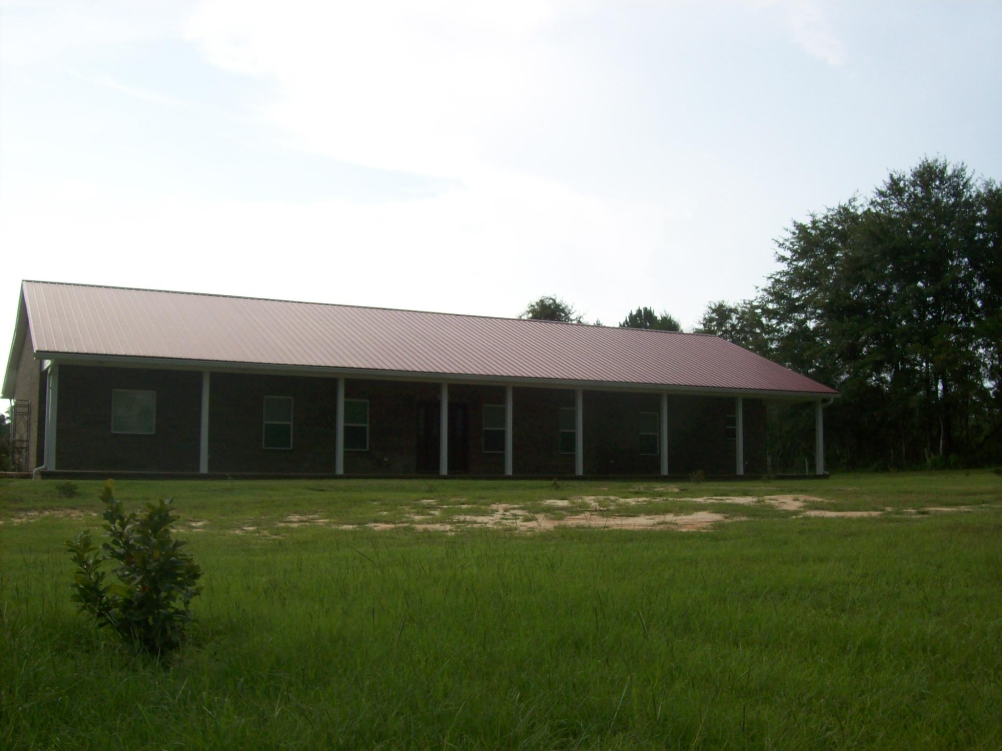 8130 Jordan Road Baker, FL 32531 - Photo 1 of 61 a front view of a house with a garden