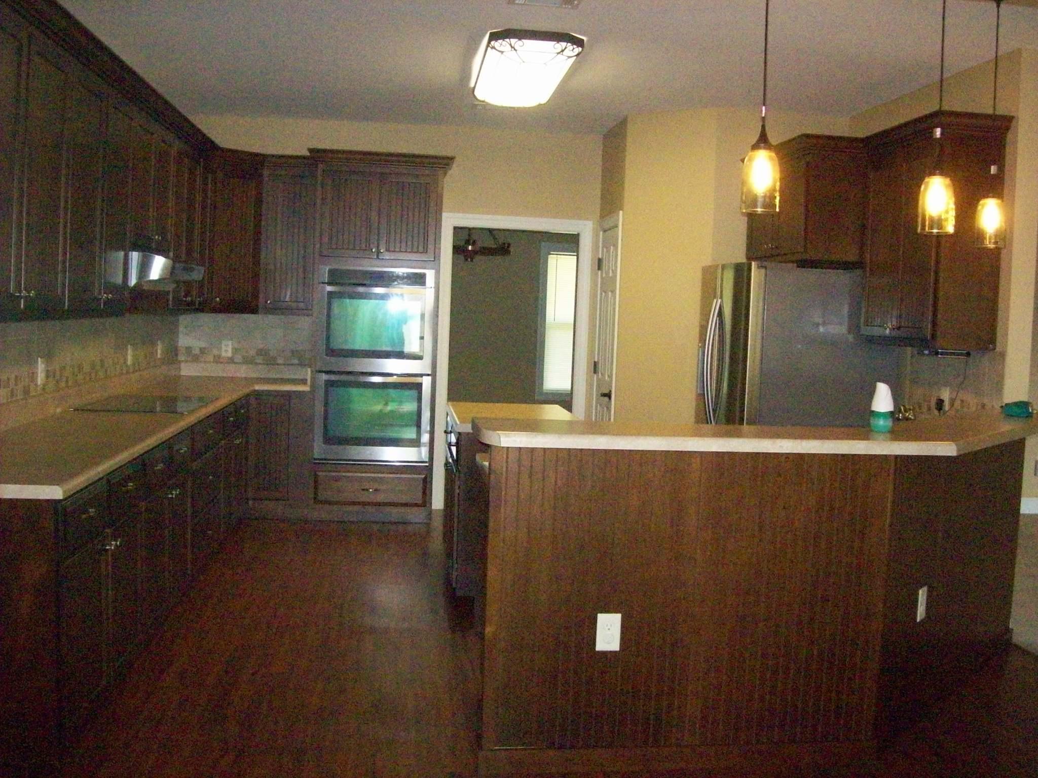 8130 Jordan Road Baker, FL 32531 - Photo 3 of 61 a kitchen with stainless steel appliances granite countertop a refrigerator a oven a sink with wooden cabinets and wooden floor