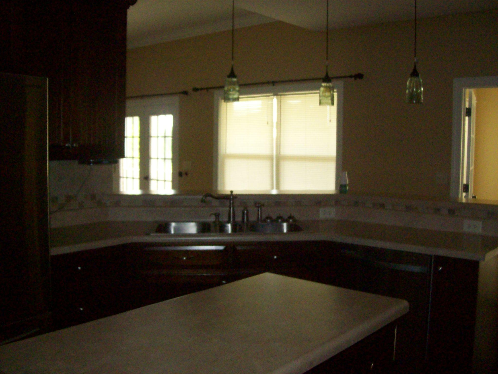 8130 Jordan Road Baker, FL 32531 - Photo 29 of 61 a kitchen with a sink a window and cabinets