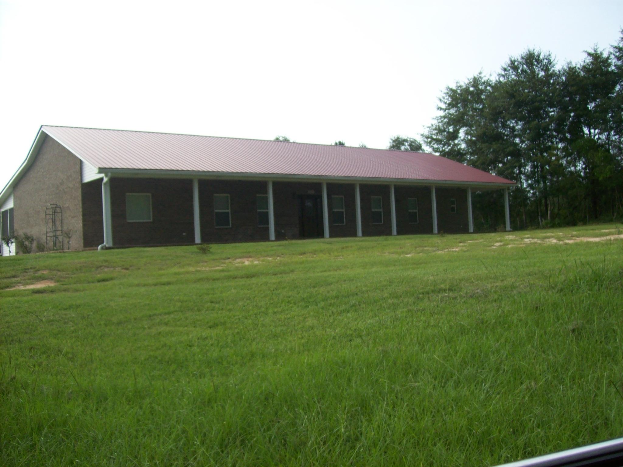 8130 Jordan Road Baker, FL 32531 - Photo 57 of 61 a view of a white house with a big yard and large trees