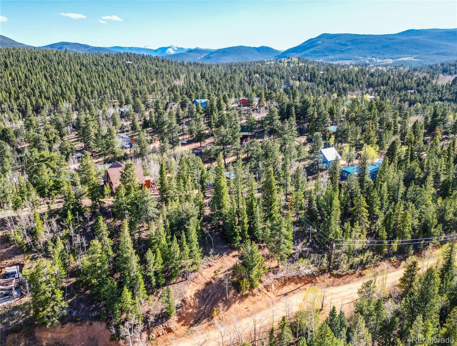 272 Wise Road Bailey, CO 80421 - Photo 8 of 21 a view of a forest with mountains in the background