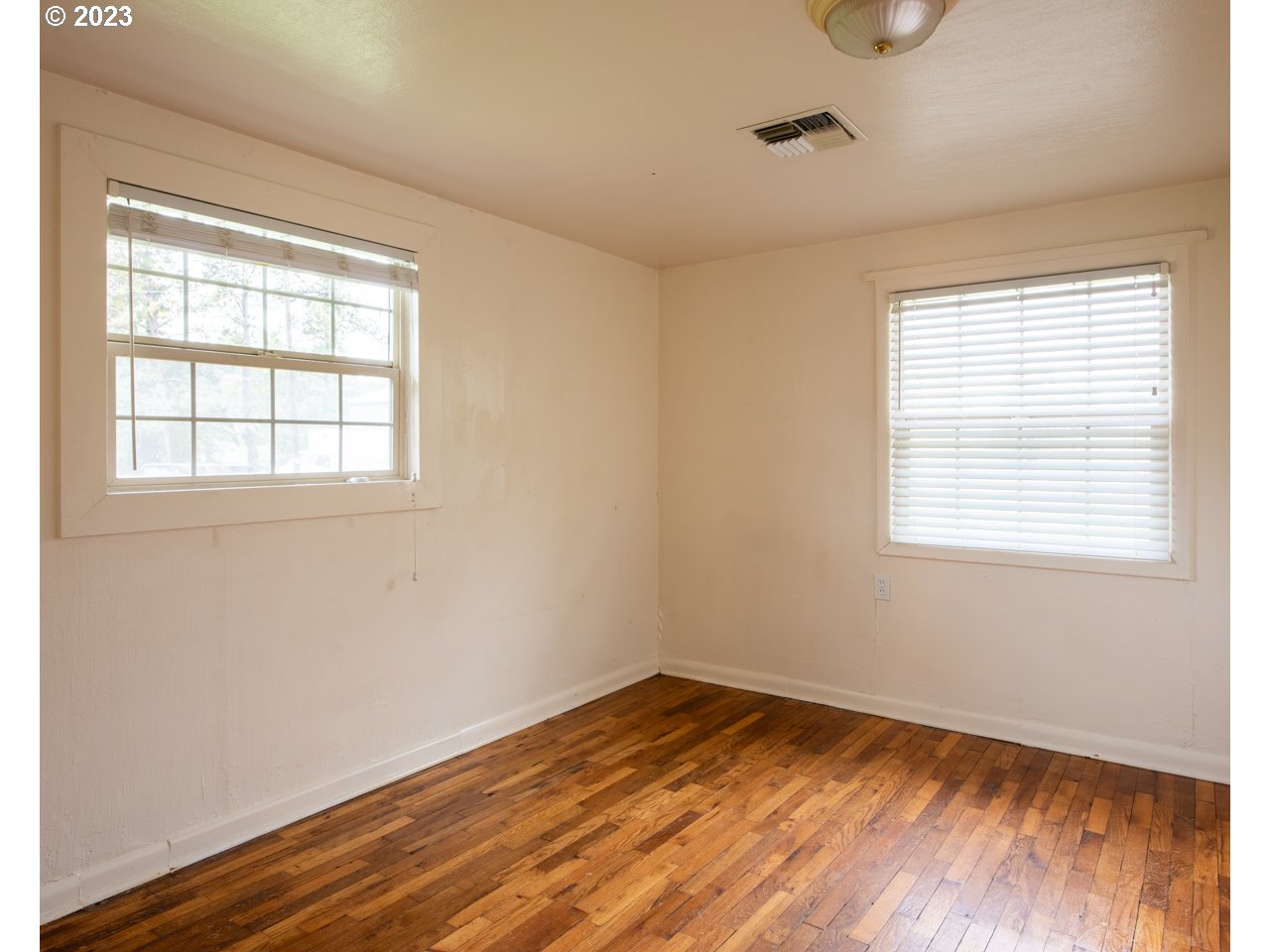 29853 Jarding Road Eugene, OR 97405 - Photo 21 of 30 a view of an empty room with wooden floor and a window