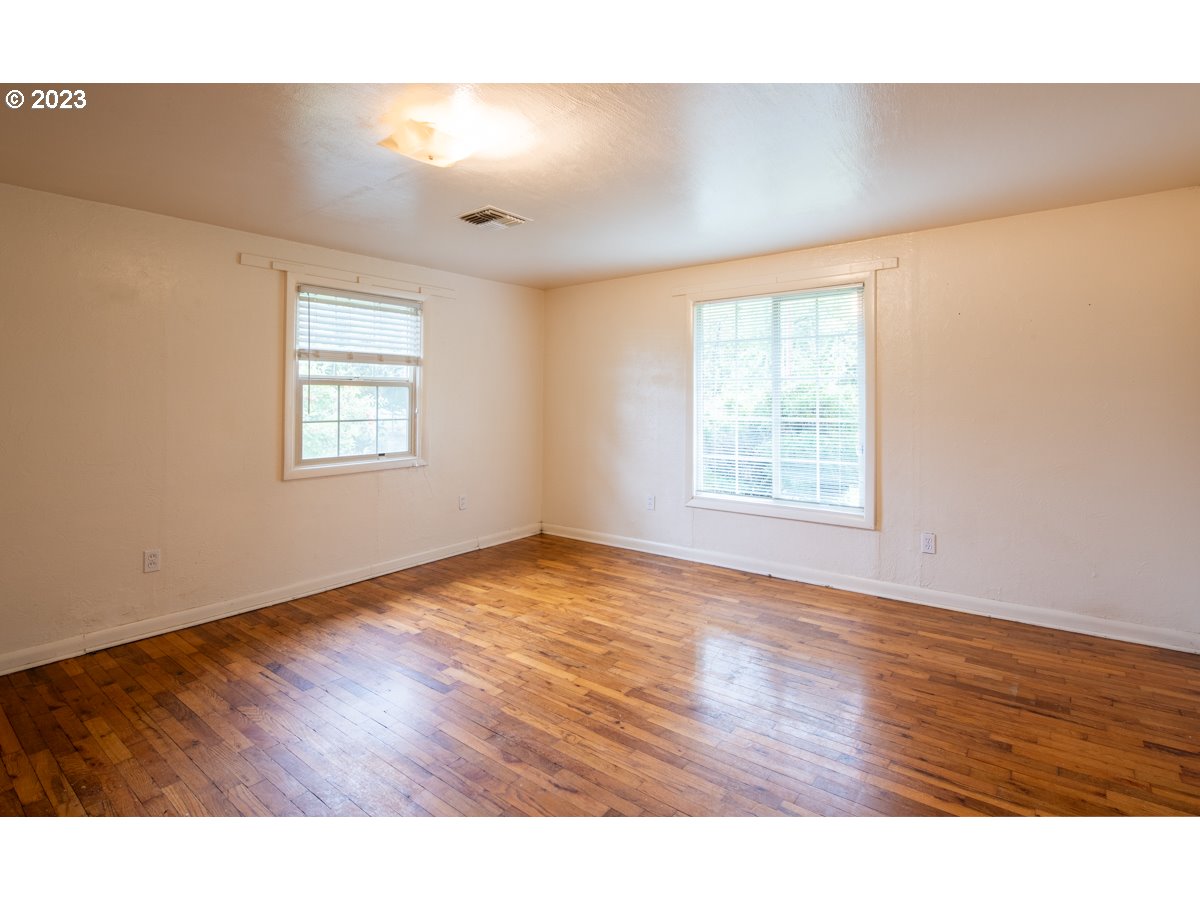 29853 Jarding Road Eugene, OR 97405 - Photo 23 of 30 a view of an empty room with wooden floor and a window