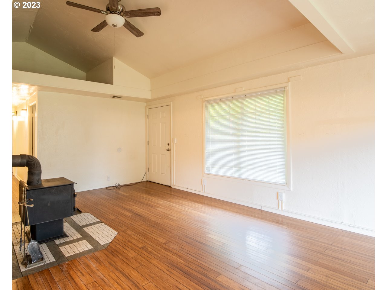 29853 Jarding Road Eugene, OR 97405 - Photo 4 of 30 a view of an empty room with a window and wooden floor