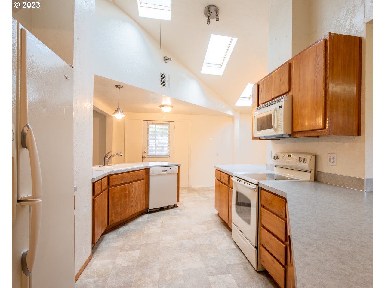 29853 Jarding Road Eugene, OR 97405 - Photo 9 of 30 a large kitchen with stainless steel appliances granite countertop a sink and dishwasher a stove top oven with wooden floor