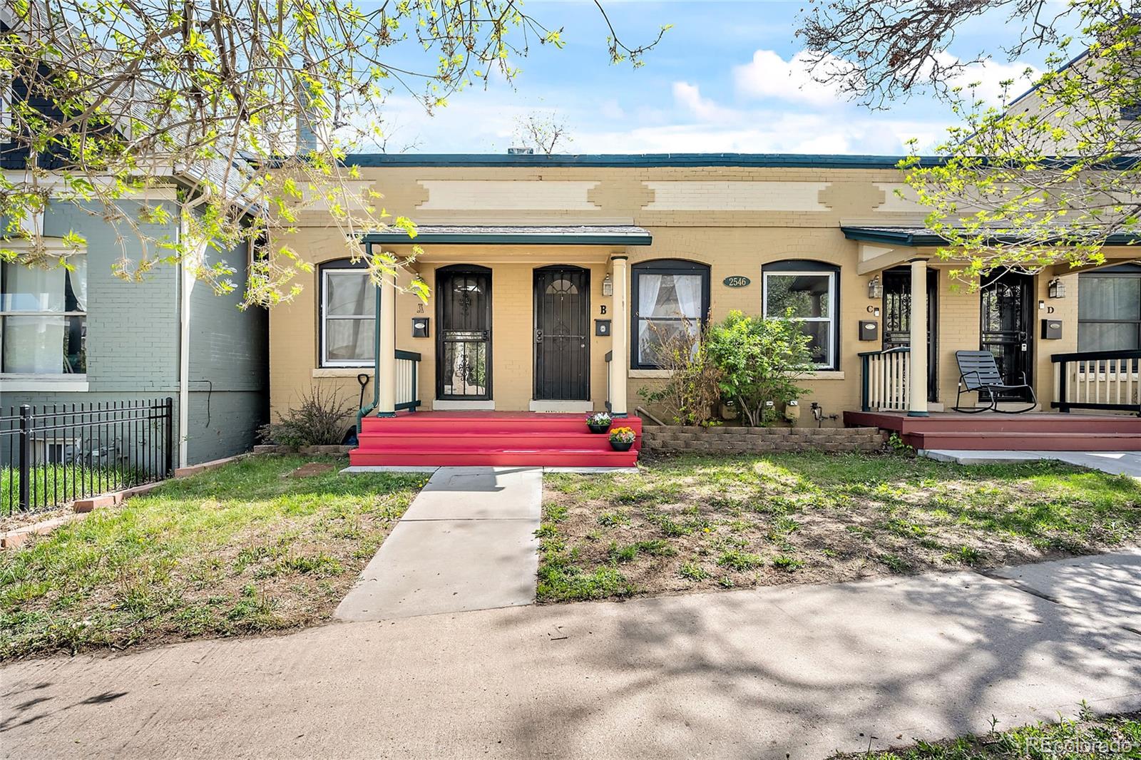 2546 West 23rd Avenue, Unit B Denver, CO 80211 - Photo 1 of 17 a view of a house with fountain and a lawn chairs next to a yard