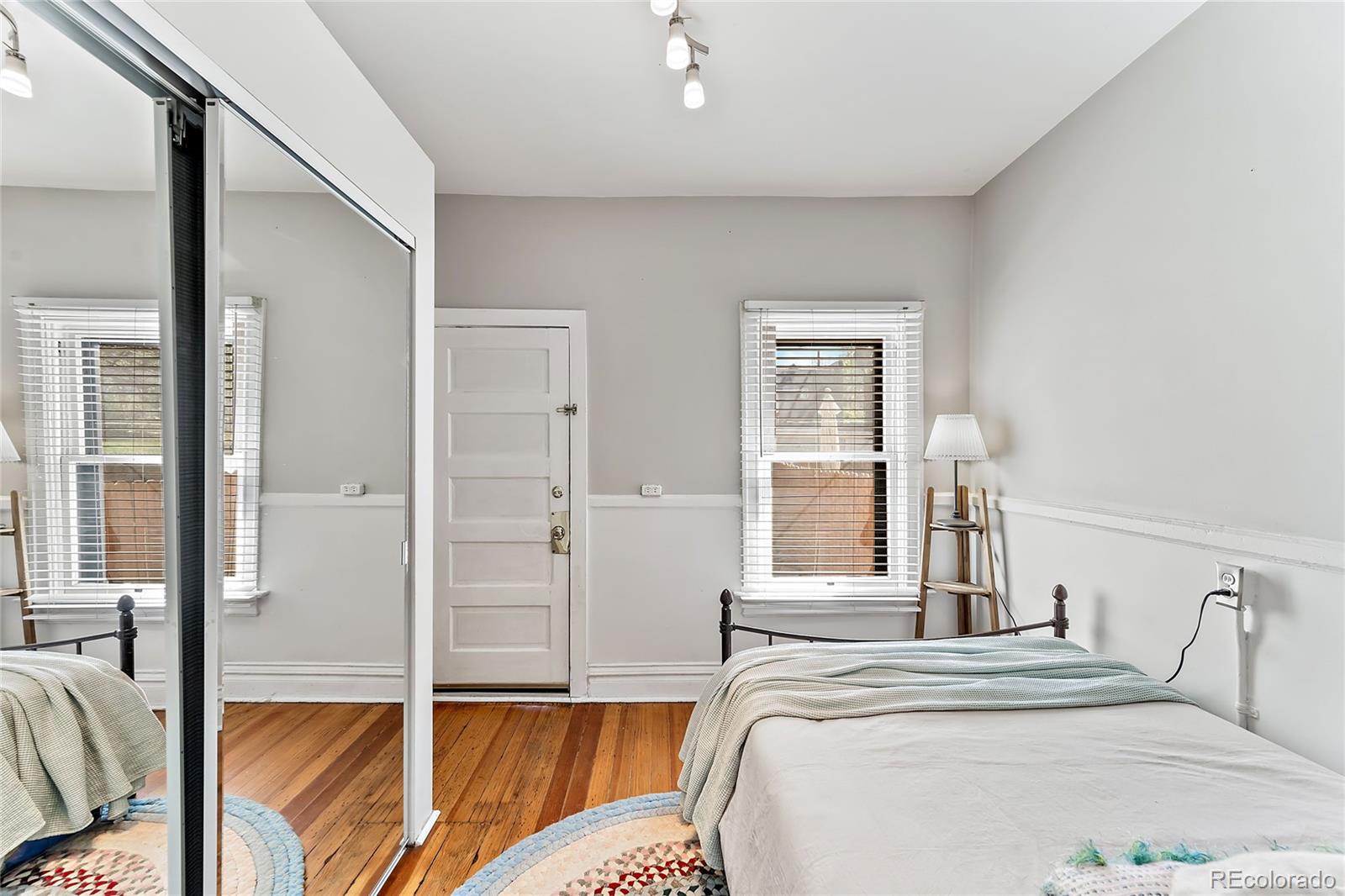 2546 West 23rd Avenue, Unit B Denver, CO 80211 - Photo 11 of 17 a bedroom with a bed and a large window