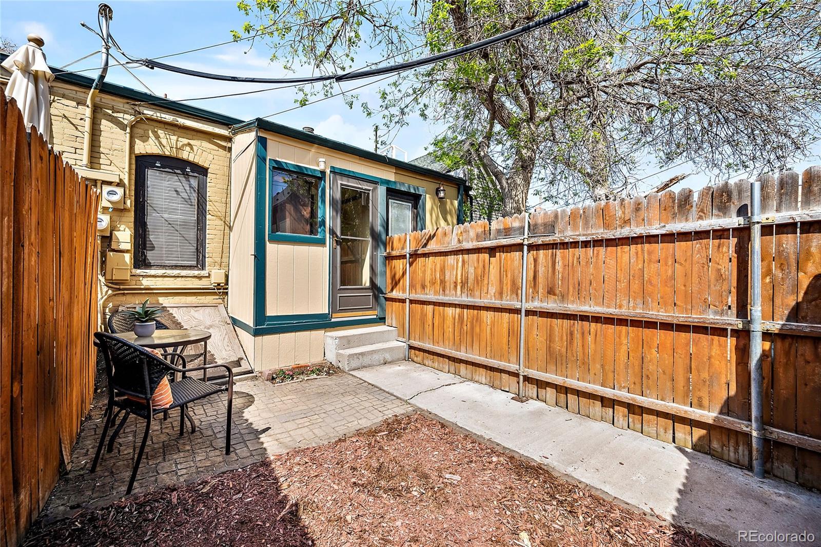 2546 West 23rd Avenue, Unit B Denver, CO 80211 - Photo 14 of 17 a view of a house with a wooden fence