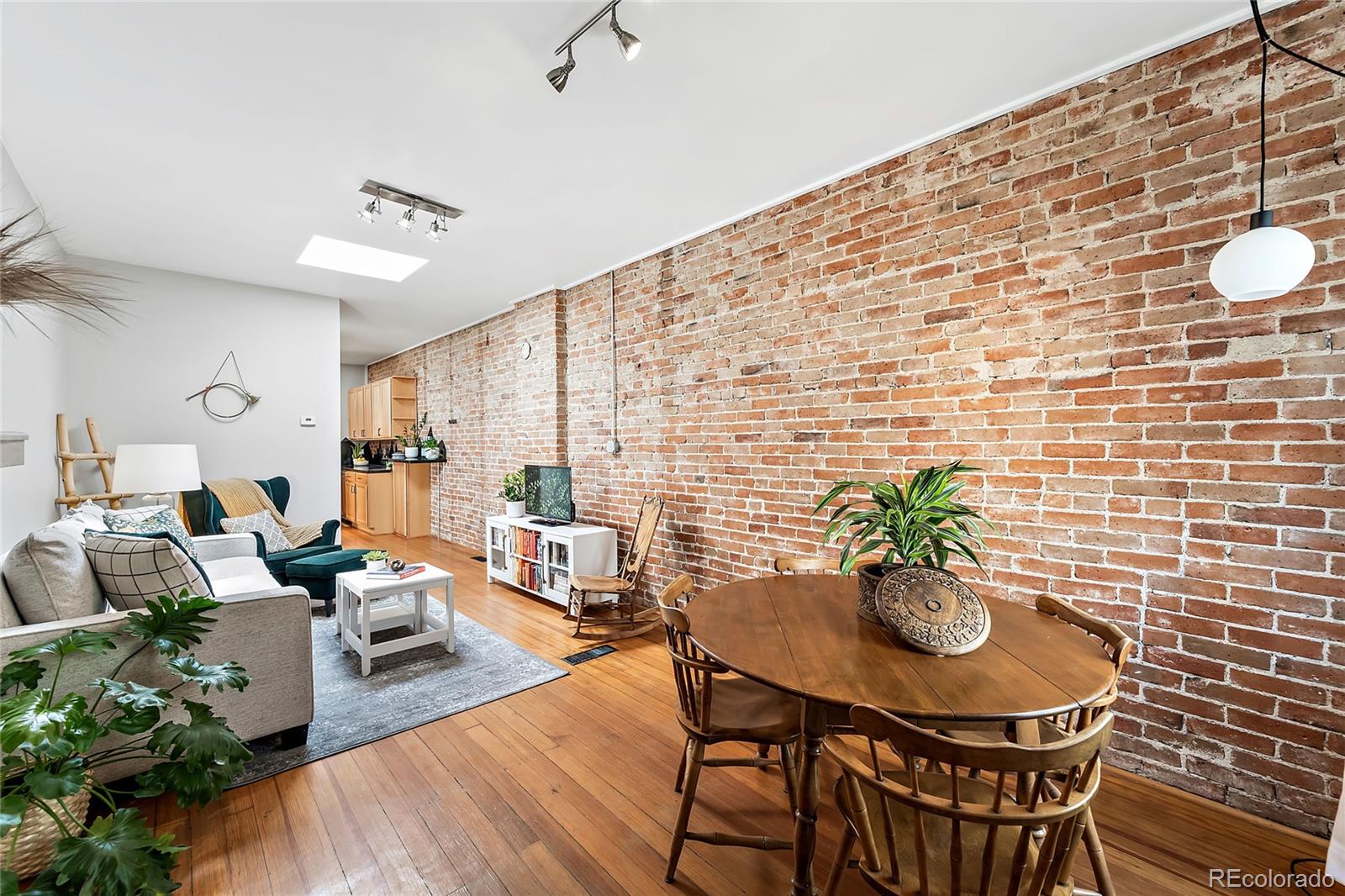 2546 West 23rd Avenue, Unit B Denver, CO 80211 - Photo 5 of 17 a view of a dining room with furniture and wooden floor