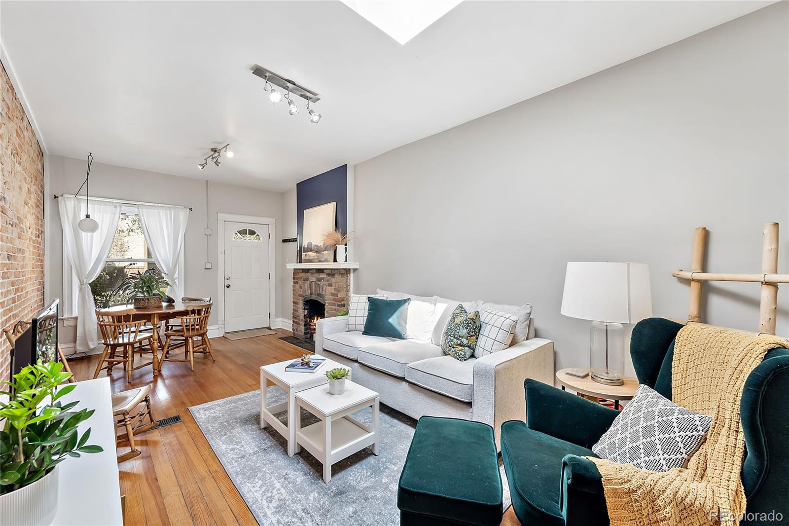 2546 West 23rd Avenue, Unit B Denver, CO 80211 - Photo 6 of 17 a living room with furniture a rug and a table