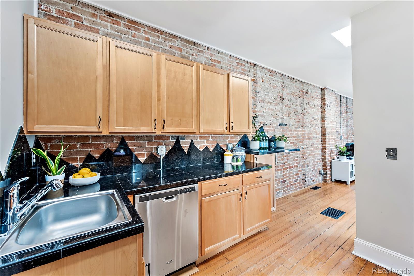 2546 West 23rd Avenue, Unit B Denver, CO 80211 - Photo 7 of 17 a kitchen with a sink a counter and cabinets