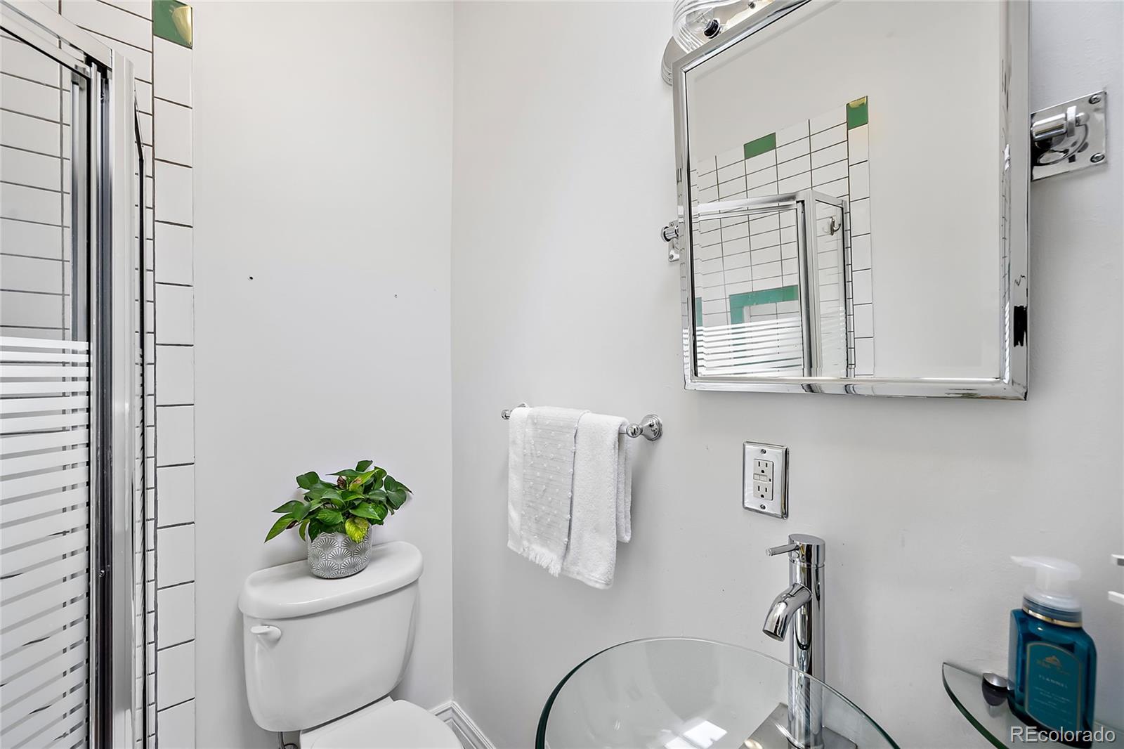 2546 West 23rd Avenue, Unit B Denver, CO 80211 - Photo 10 of 17 a bathroom with a toilet sink and mirror