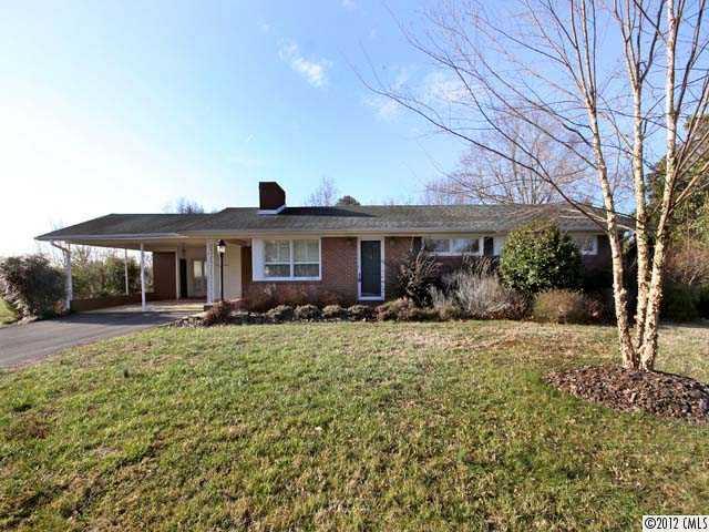 7945 Woodleaf Road Woodleaf, NC 27054 - Photo 1 of 16 a front view of a house with garden