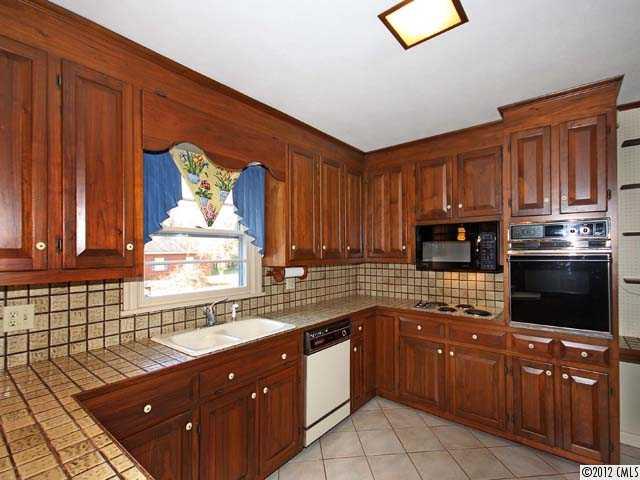 7945 Woodleaf Road Woodleaf, NC 27054 - Photo 2 of 16 a kitchen with stainless steel appliances granite countertop a refrigerator and a sink