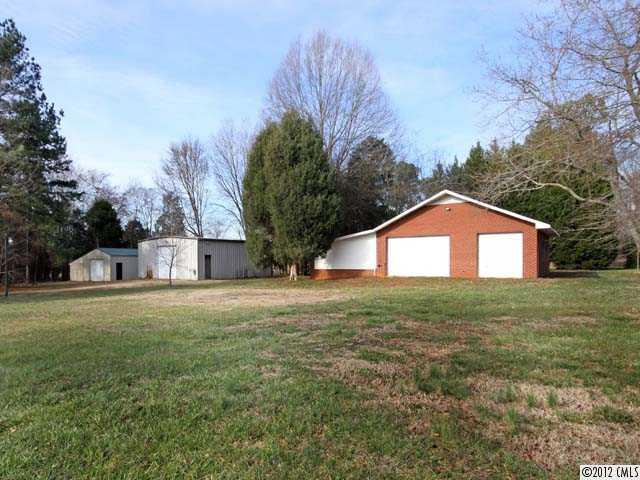 7945 Woodleaf Road Woodleaf, NC 27054 - Photo 12 of 16 a view of a yard in front of a house with large trees