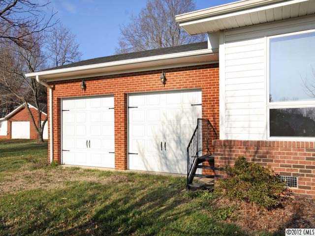 7945 Woodleaf Road Woodleaf, NC 27054 - Photo 16 of 16 a front view of a house with a yard