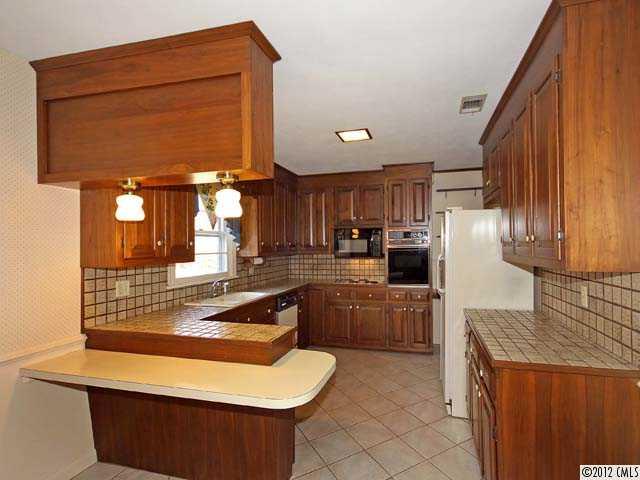 7945 Woodleaf Road Woodleaf, NC 27054 - Photo 3 of 16 a kitchen with refrigerator and cabinets