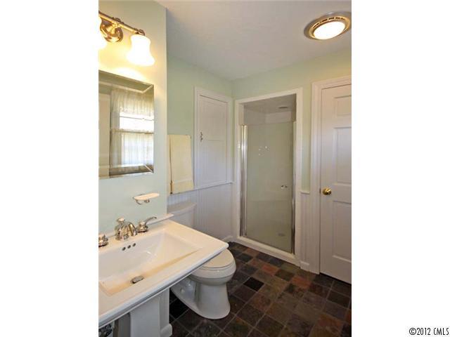 7945 Woodleaf Road Woodleaf, NC 27054 - Photo 6 of 16 a bathroom with a sink a toilet and shower