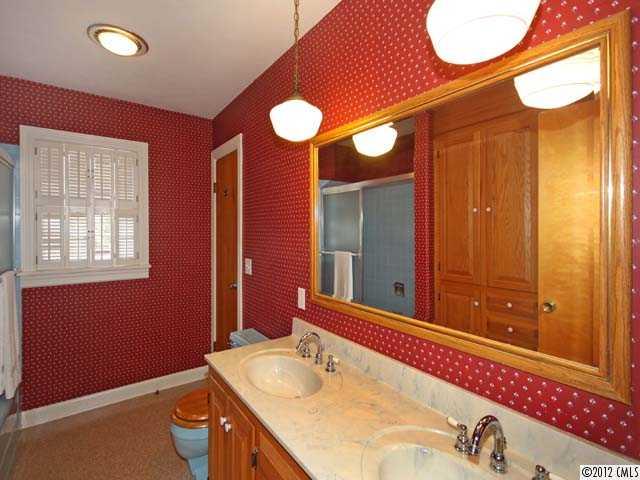 7945 Woodleaf Road Woodleaf, NC 27054 - Photo 8 of 16 a bathroom with a granite countertop sink and a mirror