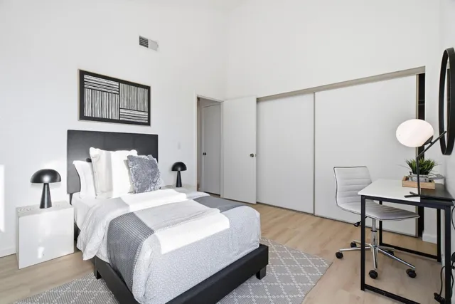 a bedroom with a bed and a table