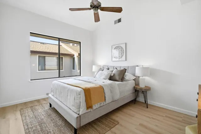 a bedroom with a bed and a window