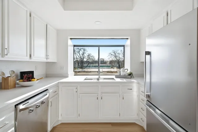 a kitchen with white cabinets and a sink