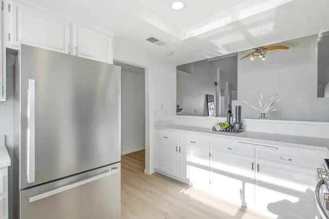 a white refrigerator freezer sitting inside of a kitchen