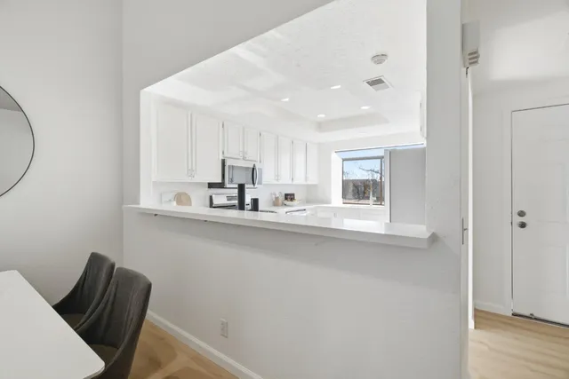 a view of a dining room with furniture and a wooden floor