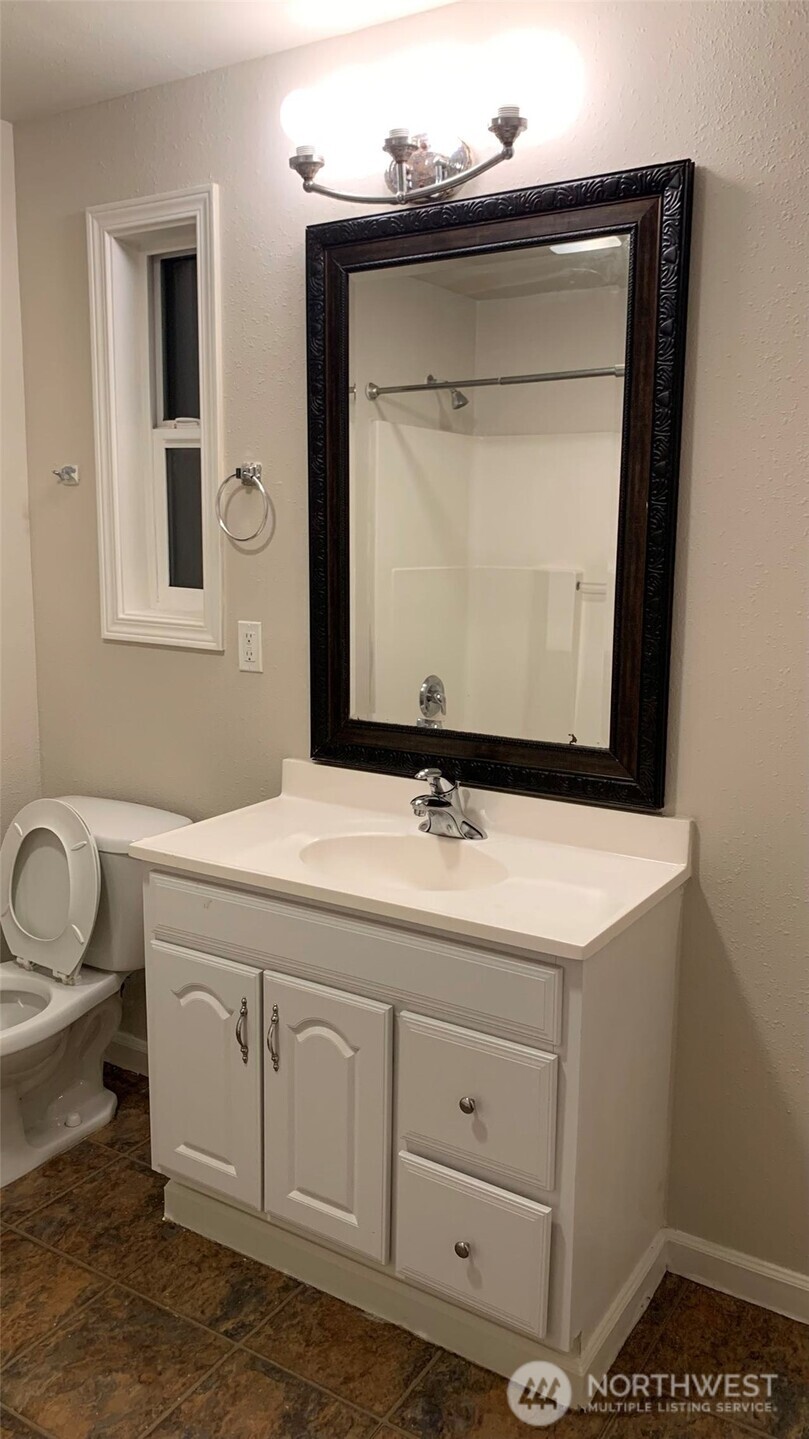 5030 212th Street Southwest Mountlake Terrace, WA 98043 - Photo 13 of 14 a bathroom with a toilet sink and mirror