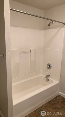 a bathroom with a shower and a bath tub