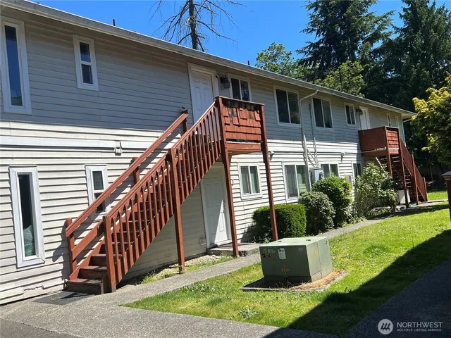 a front view of house with yard and outdoor seating