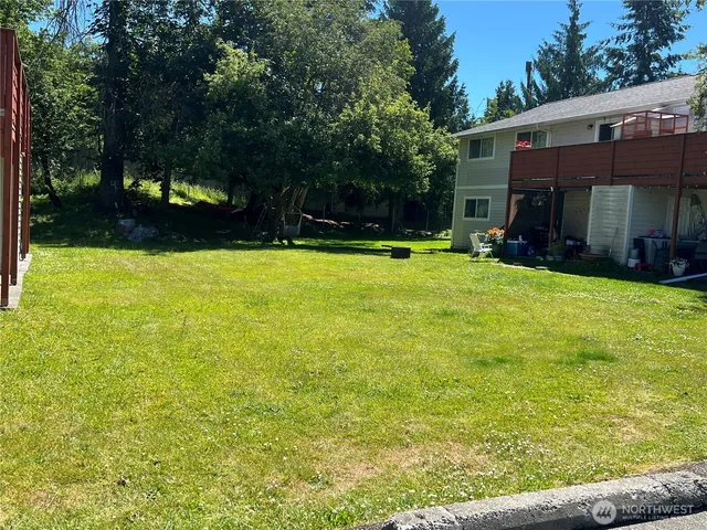 a view of a house with a yard and sitting area