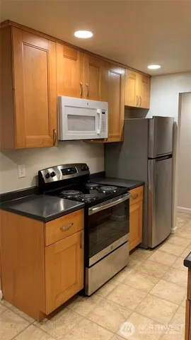 a kitchen with appliances cabinets and a counter top space