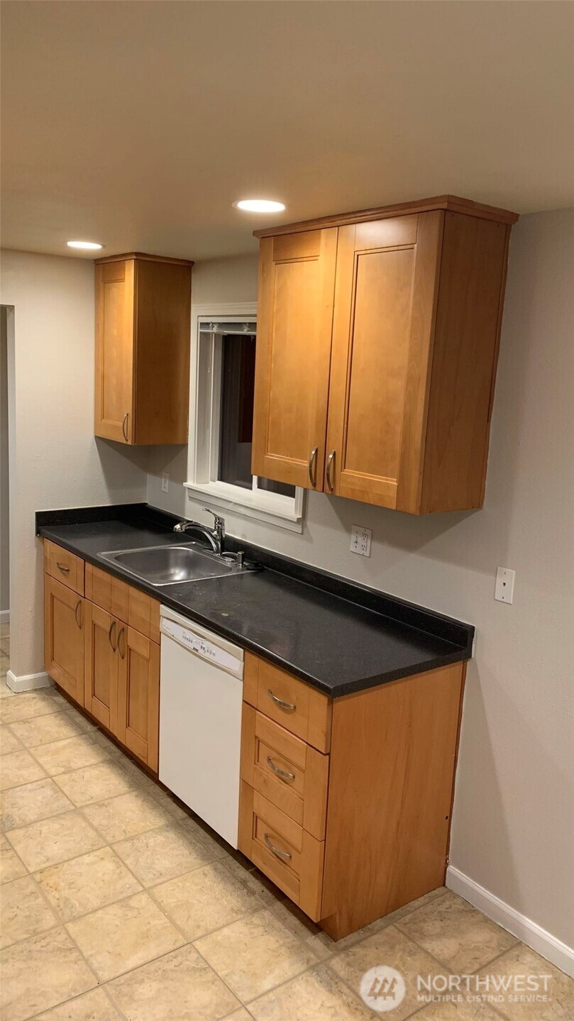 5030 212th Street Southwest Mountlake Terrace, WA 98043 - Photo 10 of 14 a kitchen with granite countertop a sink and a stove
