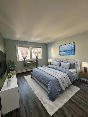 a bedroom with a large bed and a window