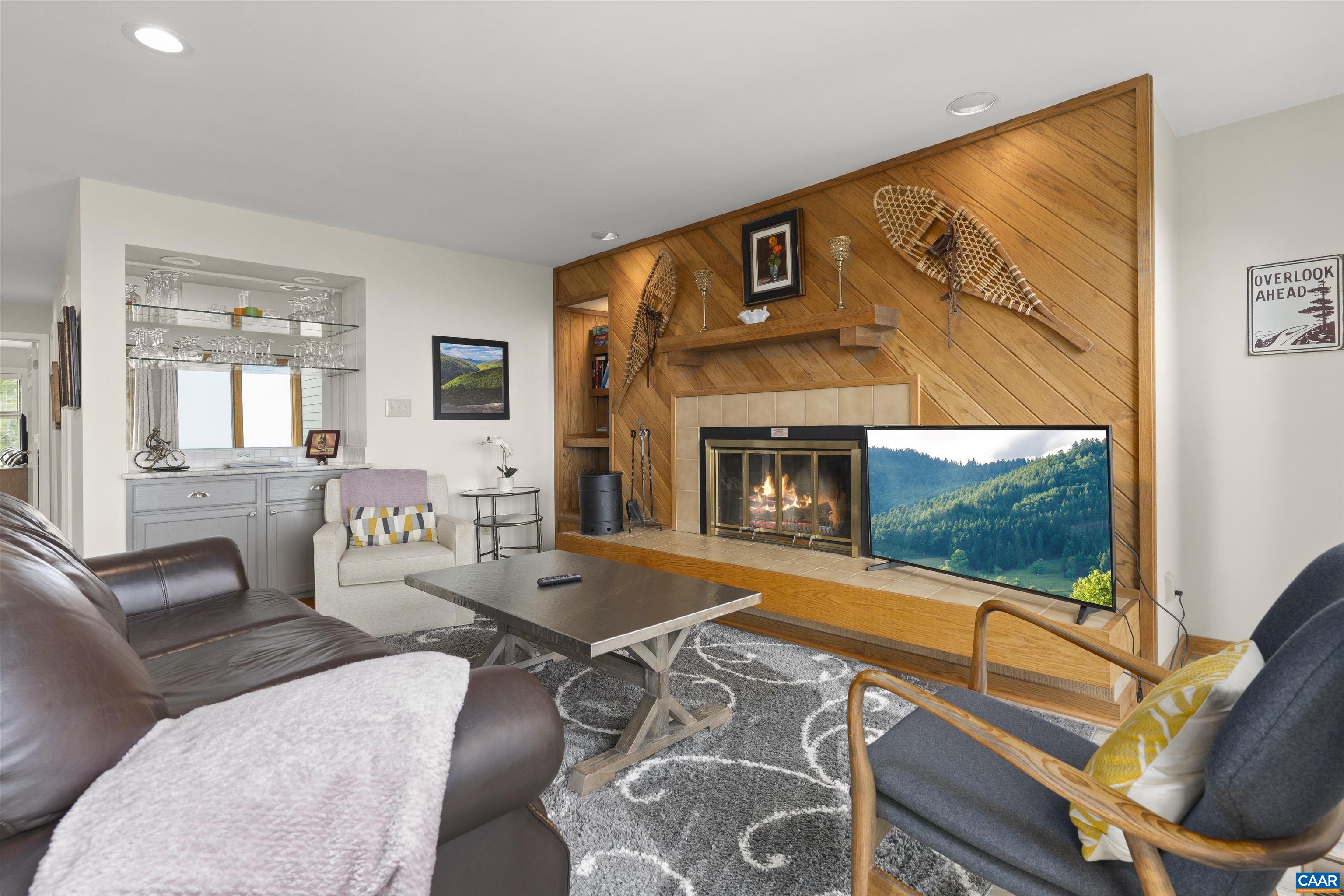 1581 Vistas Roseland, VA 22967 - Photo 14 of 53 a living room with furniture a flat screen tv and a fireplace