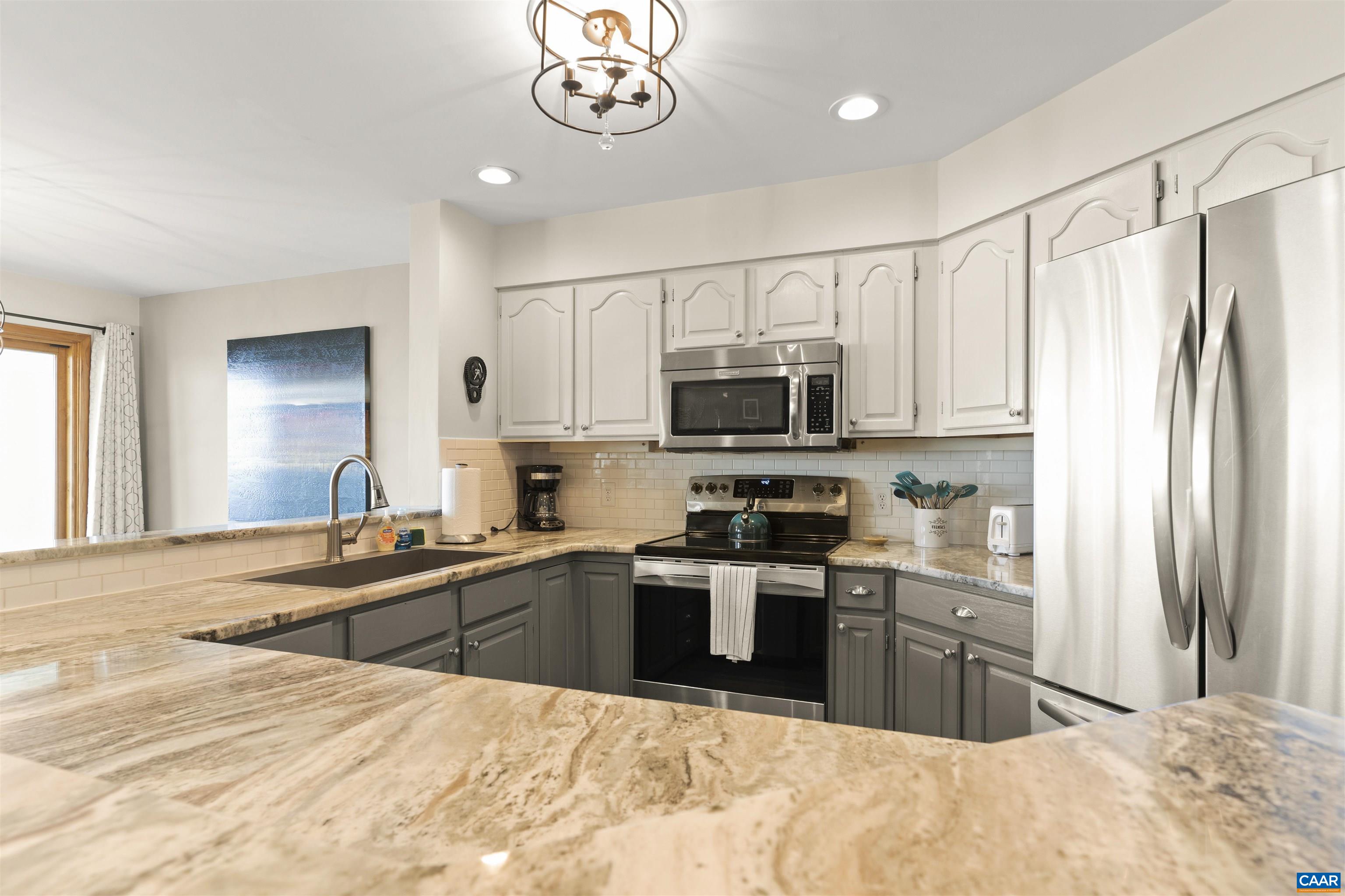 1581 Vistas Roseland, VA 22967 - Photo 17 of 53 a large kitchen with kitchen island granite countertop a sink stainless steel appliances and cabinets