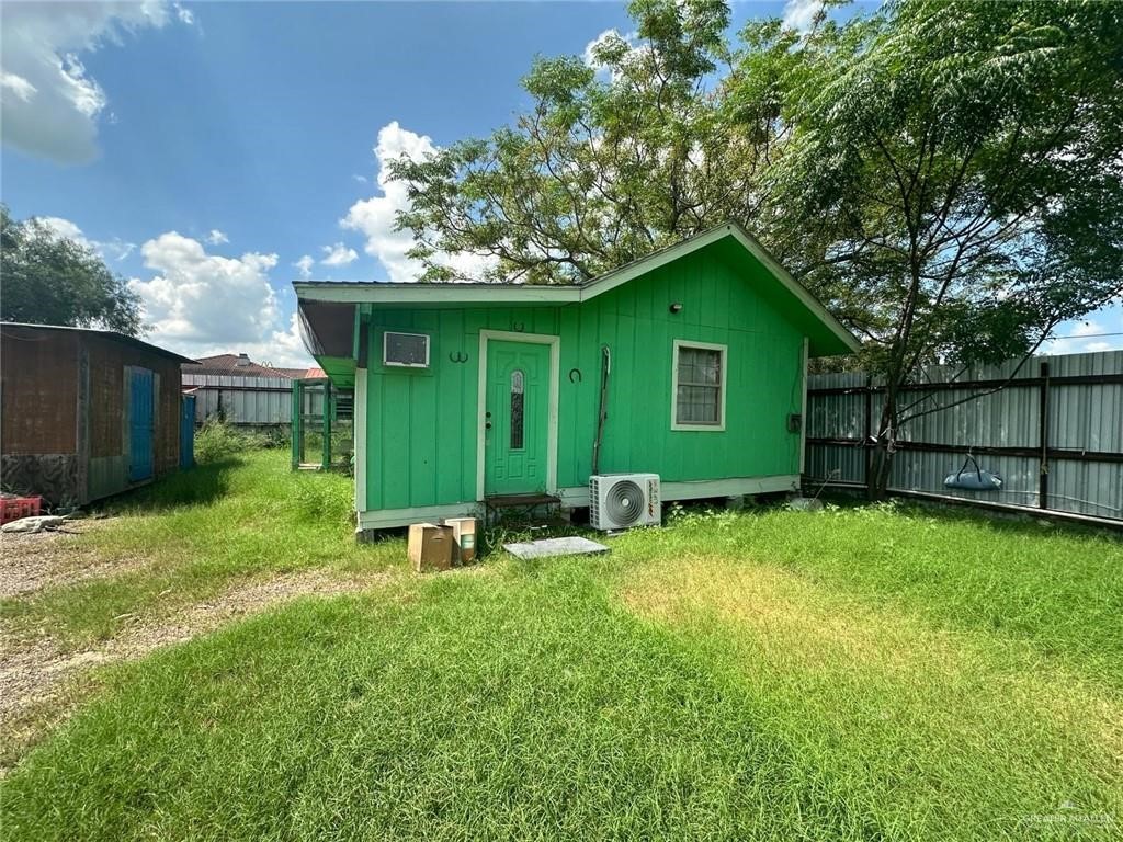 711 East Rice Street Falfurrias, TX 78355 - Photo 2 of 11 a backyard of a house with lawn chairs plants and wooden fence