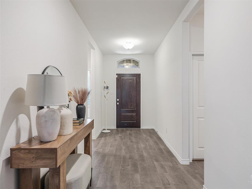 3024 Meredith Lane Forney, TX 75126 - Photo 4 of 29 Welcoming entry hall featuring wood-finish flooring, bright white walls, and a recessed ceiling light