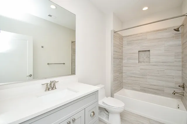 a bathroom with a sink a toilet and a bathtub