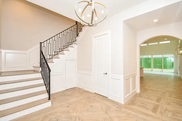 a view of entryway and hall with wooden floor