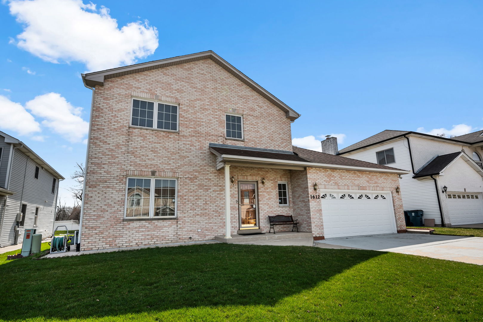 1612 Percy Lane Itasca, IL 60143 - Photo 2 of 20 a view of a white house with a big yard and large trees